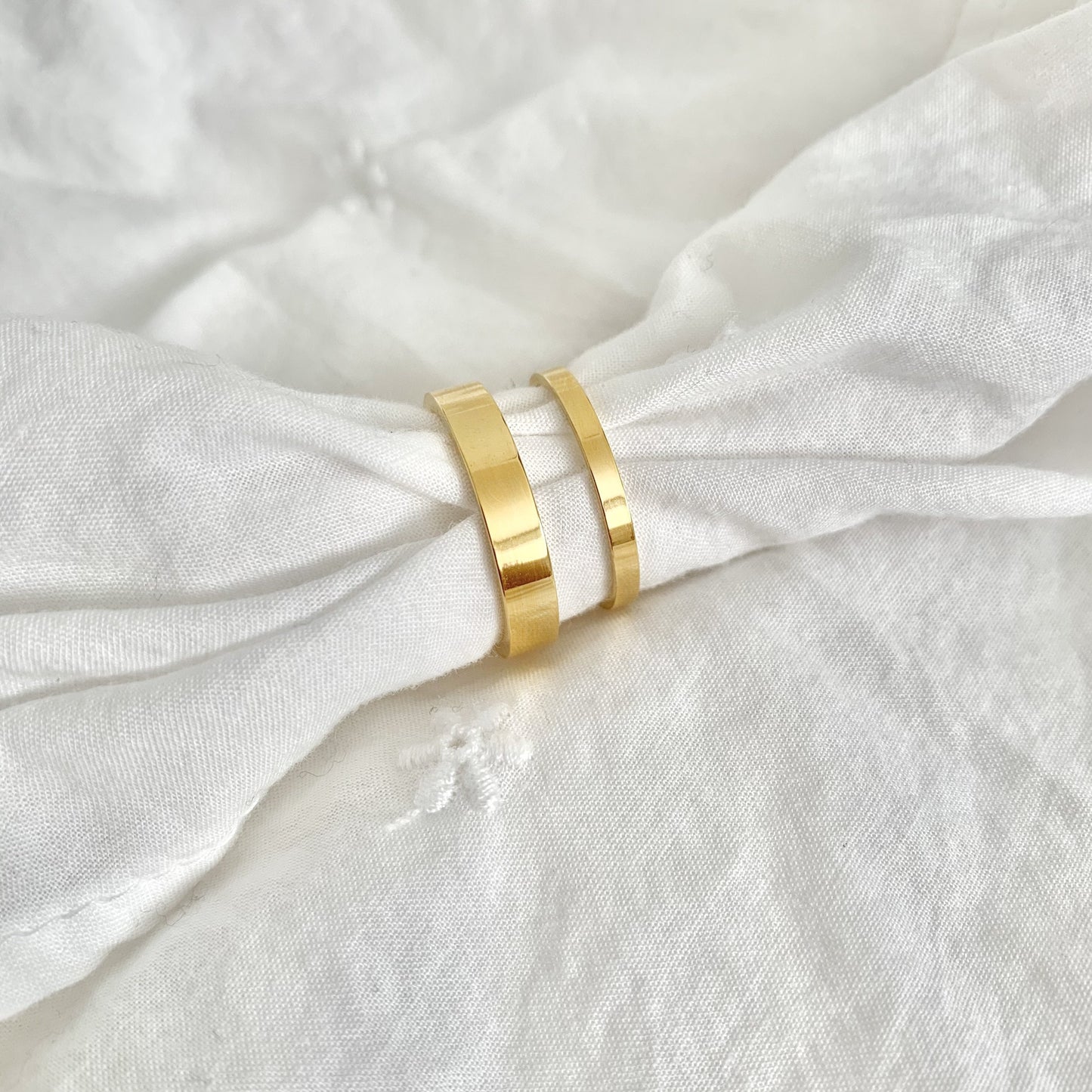 Gold ring on a white fabric background