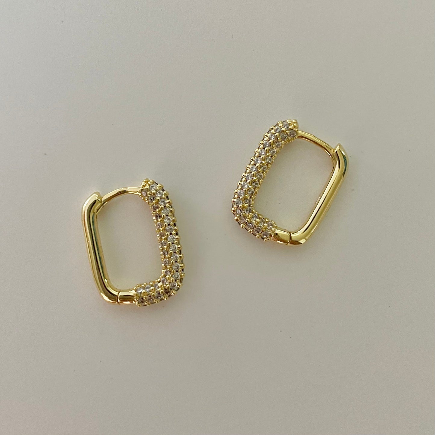 gold rectangular hoop earrings with a white zirconia pave crust
